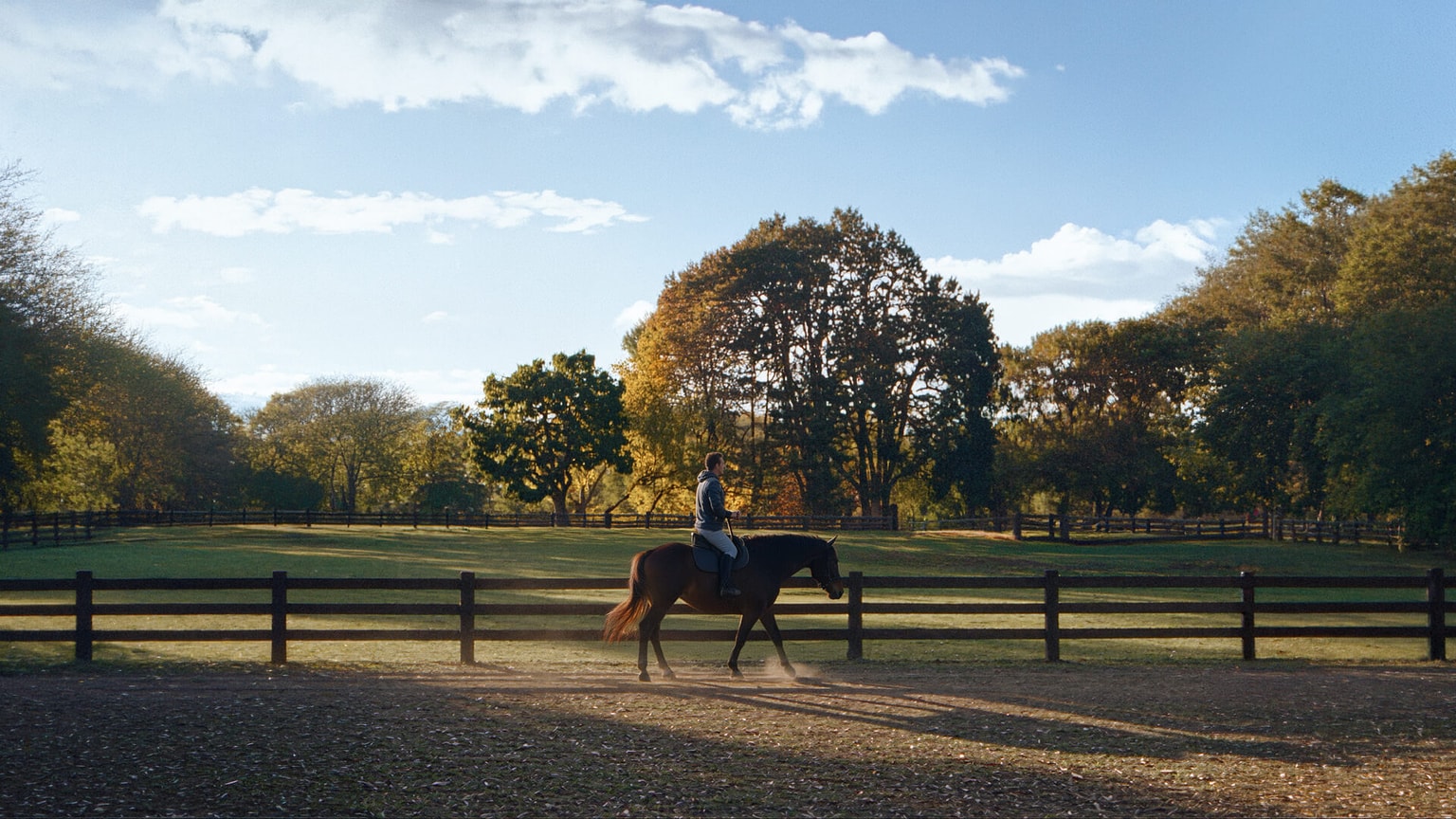 Polo match on one of the fields, with the club house in the background